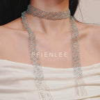 Model wearing FFIENLEE 925 sterling silver Italian lace necklace with Swarovski aqua crystal beads in double-drape style — both strands falling freely down the chest with tassel ends, styled with a white strapless dress, FFIENLEE branding