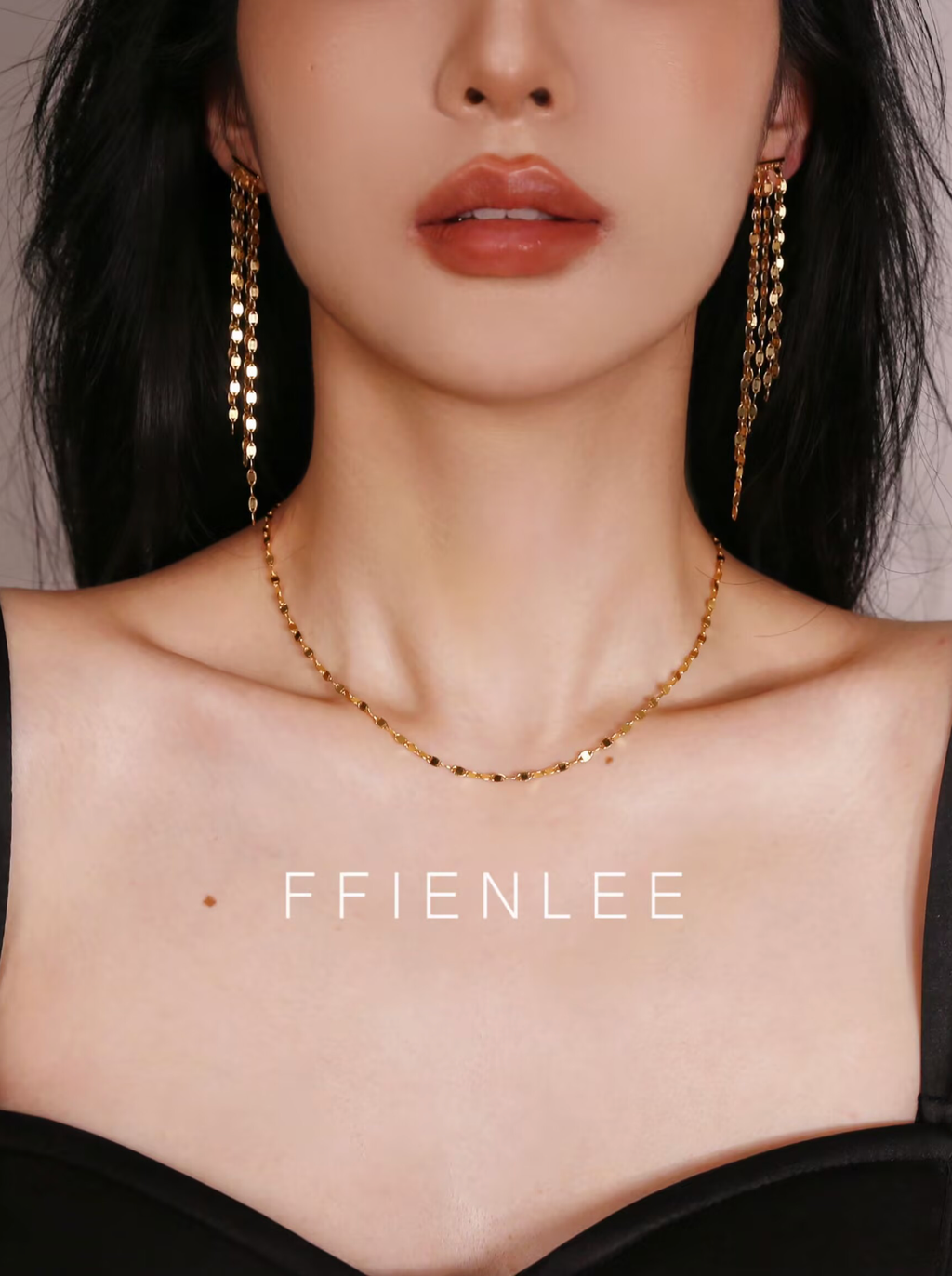 Model wearing FFIENLEE 925 sterling silver tile chain necklace in 24K gold tone with matching gold tile chain tassel earrings, styled with a black strapless top, elegant and sophisticated look, FFIENLEE branding