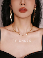 Model wearing FFIENLEE 925 sterling silver tile chain necklace in 24K gold tone with matching gold tile chain tassel earrings, styled with a black strapless top, elegant and sophisticated look, FFIENLEE branding