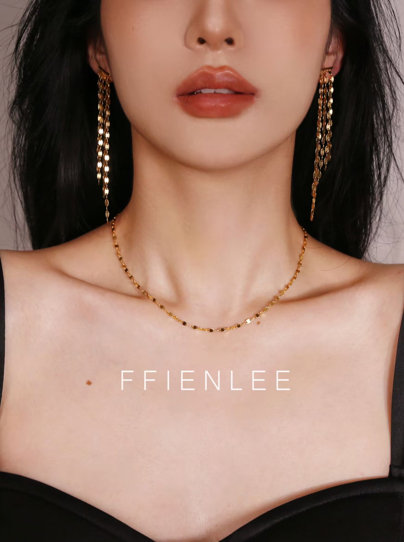 Model wearing FFIENLEE 925 sterling silver tile chain necklace in 24K gold tone with matching gold tile chain tassel earrings, styled with a black strapless top, elegant and sophisticated look, FFIENLEE branding