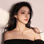Side view of long sterling silver tassel earrings showing length and movement